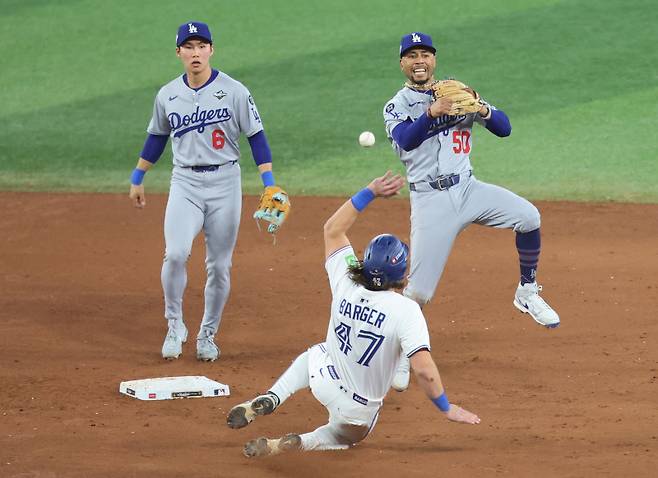 <yonhap photo-6071="">김혜성이 2일(한국시간) 토론토와 월드시리즈 7차전 연장 11회 말 1사 1, 3루에서 커터의 병살타 때 유격수 무키 베츠가 2루를 밟고 1루에 송구해 우승을 확정짓는 모습을 지켜보고 있다. UPI=연합뉴스</yonhap>