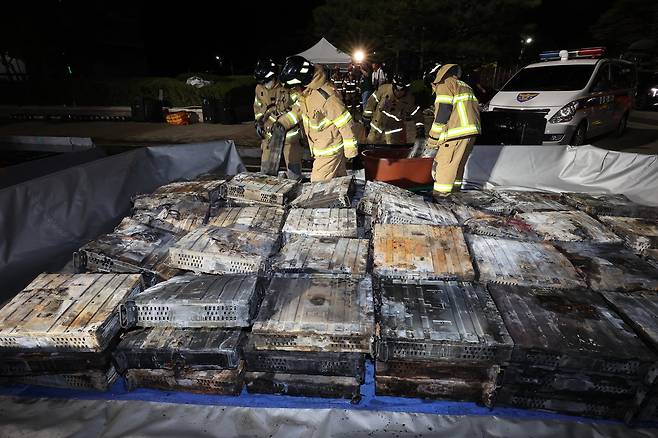 지난 9월 27일 밤 대전 유성구 국가정보자원관리원 화재 현장에서 소방대원이 소화수조에 불에 탄 리튬이온 배터리를 넣고 있다. 연합뉴스