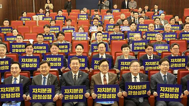 13일 국회도서관 대강에서 열린 더불어민주당 국가균형성장특별위원회 출범식 참석자들이 '자치분권과 균형성장'이 적힌 피켓을 들고 있다. 사진제공=민주당