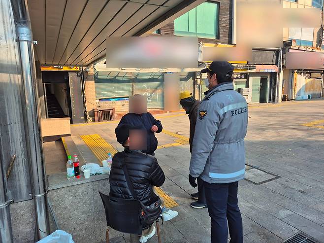 20일 서울역 4번 출구 박아론(42) 경위가 노숙인들과 대화를 하고 있다. /임희재 기자