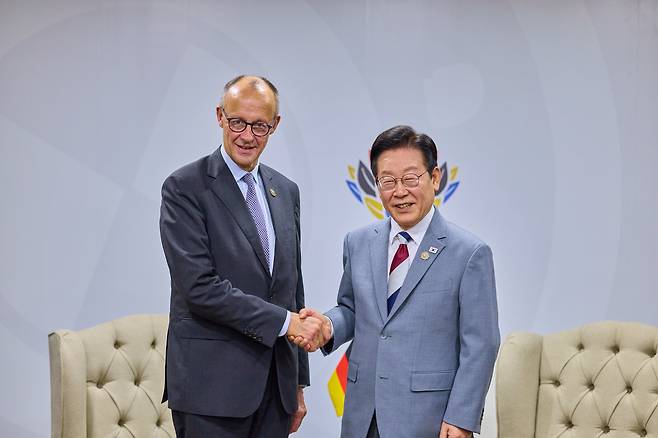 이재명 대통령과 프리드리히 메르츠 독일 총리가 22일(현지 시각) 남아프리카공화국 요하네스버그 나스렉 엑스포센터에서 열린 정상회담에서 악수하고 있다./연합뉴스