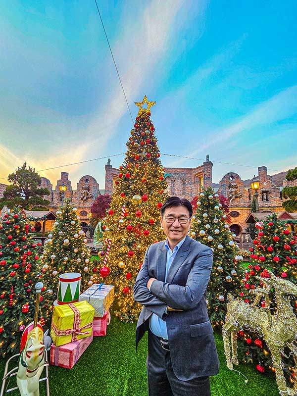 박기영 회장이 크리스마스를 앞두고 새로 단장한 루덴시아 플라자의 크리스마스트리를 배경으로 포즈를 취했다. 외유내강형인 박 회장은