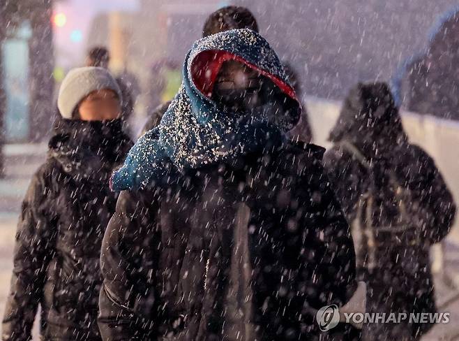 '첫 눈 치고는 꽤 많은 눈' (서울=연합뉴스) 최재구 기자 = 서울 지역에 올해 첫눈이 내린 4일 서울 광화문에서 시민들이 눈을 맞으며 길을 걷고 있다. 2025.12.4 jjaeck9@yna.co.kr