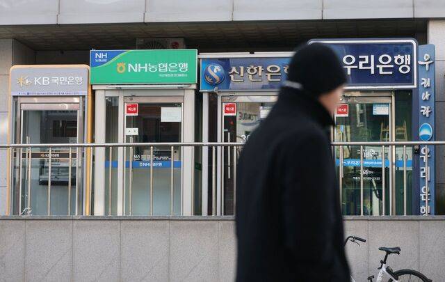 한 시민이 14일 서울시내에 설치된 현금자동입출금기(ATM) 앞을 지나고 있다. 금융권에 따르면 5대 은행(KB·신한·하나·우리·NH농협)의 지난 11일 기준 개인 마이너스통장 잔액은 40조7582억원으로, 11월 말(40조837억원)보다 약 6745억원 증가했다. 역대 월말과 비교하면 2022년 12월 말(42조546억원) 이후 최대다. 6·27 부동산 대책 등으로 주택담보대출 한도 등을 조이면서 ‘풍선효과’로 마이너스통장 잔액이 증가한 것으로 분석된다. 연합뉴스