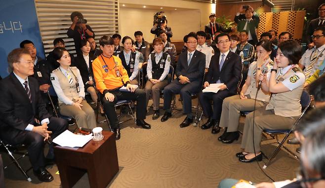 문재인 대통령이 지난 2017년 5월 12일 인천공항공사에서 열린 '찾아가는 대통령, 공공부문 비정규직 제로시대를 열겠습니다!' 행사에 참석하해 비정규직 문제 해결을 건의하며 눈물을 닦는 참석자를 보고 있다. 뉴시스