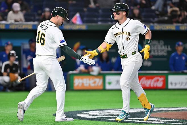 Australia's Travis Bazzana (R) celebrates his home run with teammate Curtis Mead (L) in the seventh inning of the World Baseball Classic (WBC) Pool C first round game between Australia and Taiwan at the Tokyo Dome on March 5, 2026. AP연합뉴스