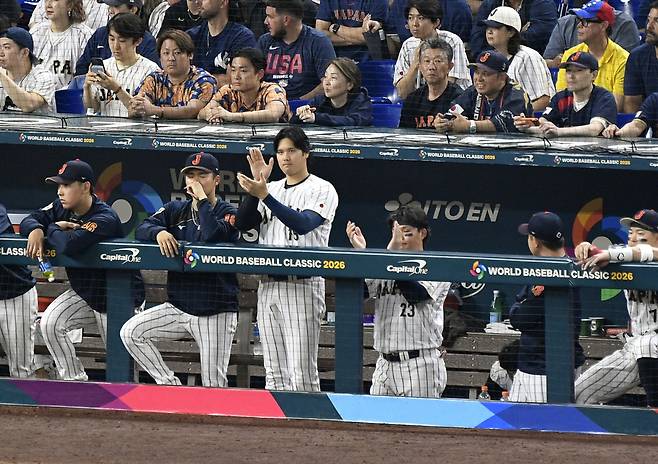Japan designated hitter Shohei Ohtani cheers for his team during the ninth inning against Japan at loanDepot Park in Miami, Florida on Saturday, March 14, 2026. UPI연합뉴스