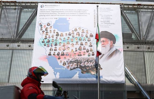 지난 12일 서울 용산구 주한 이란대사관 외벽에 미국과 이스라엘을 비판하는 내용의 대형 현수막이 걸려 있다. 현수막에는 미국이스라엘 공습으로 사망한 알리 하메네이 전 최고지도자의 사진과 함께 '세계는 언제 전쟁범죄자들에게 책임을 물을 것인가?'라는 영문 문구가 담겼다. 뉴스1