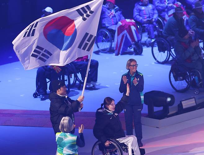 15일(현지시간) 이탈리아 코르티나 컬링 올림픽 스타디움에서 열린 2026 밀라노·코르티나 동계패럴림픽 폐막식에서 대한민국 선수단 기수 이제혁과 백혜진이 입장하고 있다. 사진 | 코르티나=연합뉴스