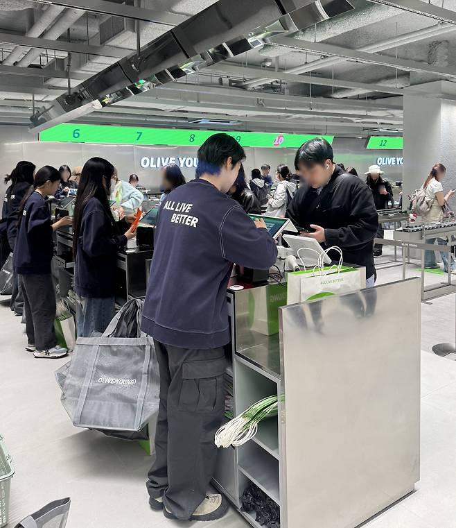 Customers check out at Olive Young's newest Myeongdong branch on Thursday. (No Kyung-min/The Korea Herald)