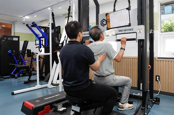 서재영 운동관리사가 30일 서울 성동구 사근 스마트 헬스케어센터에서 한 주민에게 맞춤형 운동지도를 하고 있다. 성동구 제공