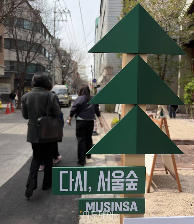 3일 오후 서울 성동구 서울숲 아뜰리에길에 설치된 "다시, 서울숲" 표지판 앞을 시민들이 지나가고 있다.(사진=황민주 기자 minchu@)