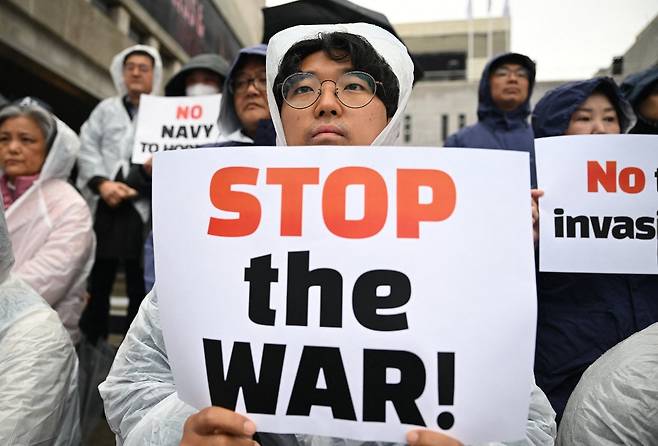 지난달 18일 서울 주한 미국대사관 인근에서 열린 집회에서 한국 시위대가 이란 전쟁을 중단하란 팻말을 들고 있다./AFPBBNews=뉴스1