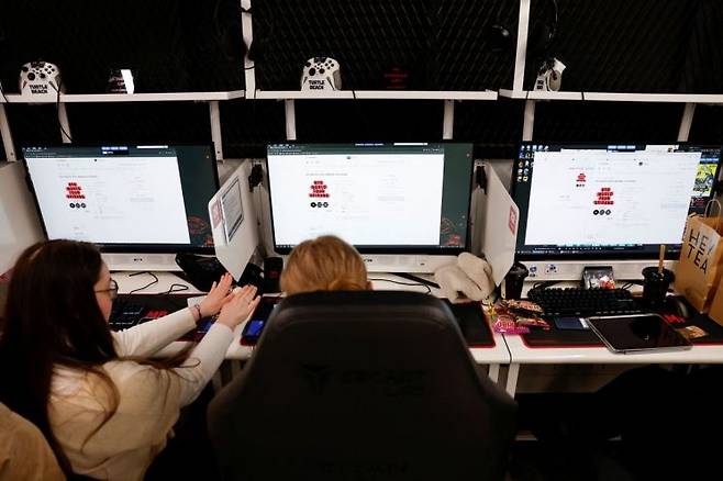 방탄소년단의 팬들이 월드 투어 한국 콘서트 티켓이 열리기를 기다리며 서울의 한 PC방에서 스크린 앞에 앉아 있다. 로이터연합뉴스