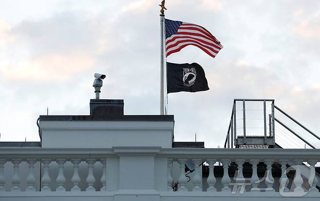 미국 워싱턴D.C. 백악관에 달린 성조기와 그 아래 전쟁포로(POW)와 전쟁 실종자(MIA)를 상징하는 검은색 깃발이 펄럭이고 있다. 2014.09.19 ⓒ 로이터=뉴스1