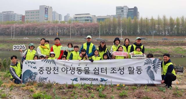 이노션이 지난 11일 서울 성동구 중랑천 일대에서 진행한 야생동물쉼터 조성 봉사활동에 참가한 임직원 가족들이 기념사진을 찍고 있다. 이노션 제공