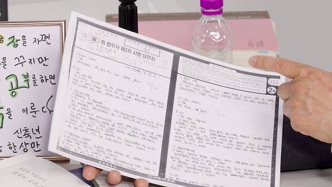 한상범 법무사가 실제 활용한 2차 시험 답안지를 들고 합격 노하우를 알려주고 있는 모습.