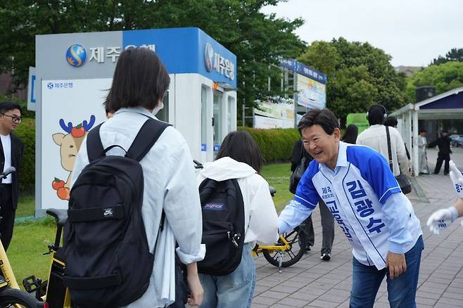 김광수 제주특별자치도교육감 후보가 21일 오전 제주대학교 정문 앞에서 학생에게 인사하고 있다. 김 후보는 공식 선거운동 첫 일정으로 제주대를 찾아 대학생 연계 교육활동 확대를 약속했다. /사진=김광수 후보 측 제공