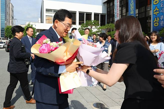 3선에 성공한 주낙영 경주시장이 4일 오전 경주시청 현관에서 직원들로부터 축하 꽃다발을 받고 있다. /독자 제공