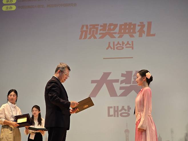 13일, 제25회 '한어교' 세계중국어대회 한국지역 결선전에서 대상을 수상한 국민대학교 이서연 학생이 시상식에서 주한중국대사관 마이구이성 공사로부터 상장을 수여받고 있다. (이창호 한중교류촉진위원회 위원장 제공)