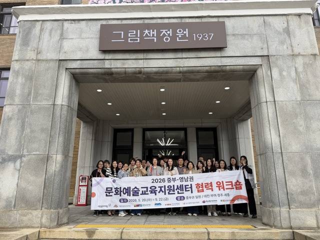 ▲ 전국 문화예술교육지원센터 관계자들이 그림책정원 앞에서 기념사진을 촬영하고 있다. /충북문화재단 제공