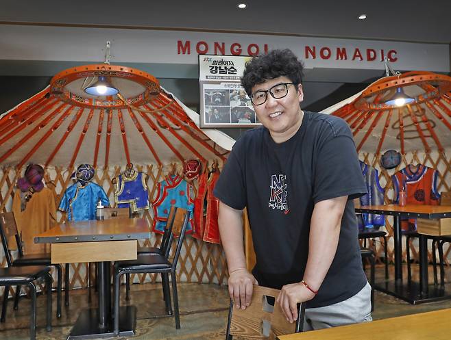 Enkhtungalag Javkhlantugs, owner of the Mongolian restaurant Mongol Nomadic, poses in front of tables decorated with miniature gers (traditional Mongolian homes). PARK SANG-MOON