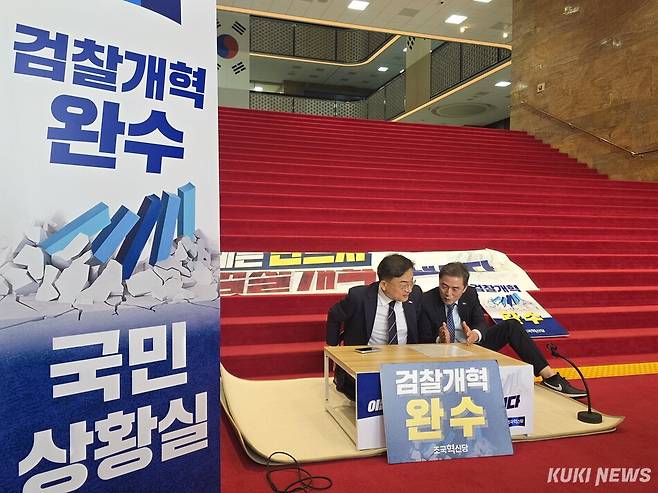 (사진 왼쪽)신장식 조국혁신당 신임 당대표가 27일 서울 여의도 국회 본관 로텐더홀 아래 계단에 ‘검찰개혁 완수 국민상황실‘을 설치한 뒤 착석해 있다. 김미경 기자.