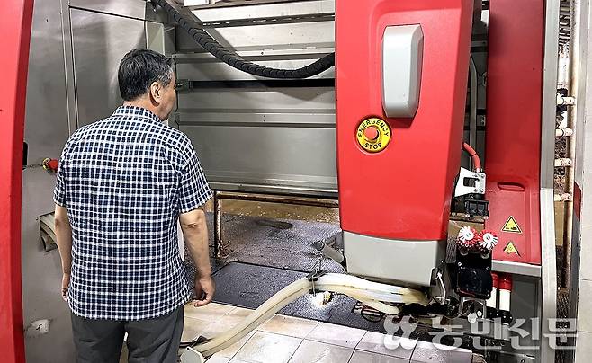 제주 제주시 낙농가 김정옥씨가 목장에 설치한 로봇착유기를 점검하고 있다.