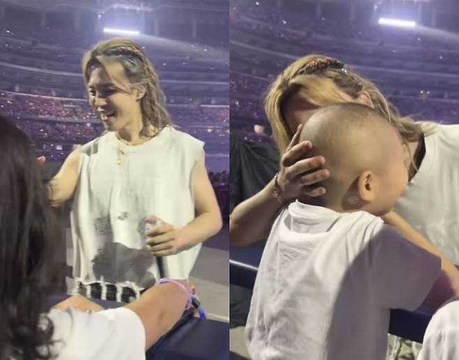 Jimin, membro do BTS, se aproximou de uma fã que luta contra o câncer infantil no local do show da turnê mundial nos EUA e lhe deu um beijo na bochecha. Foto tirada do Instagram @heroesforchildren.