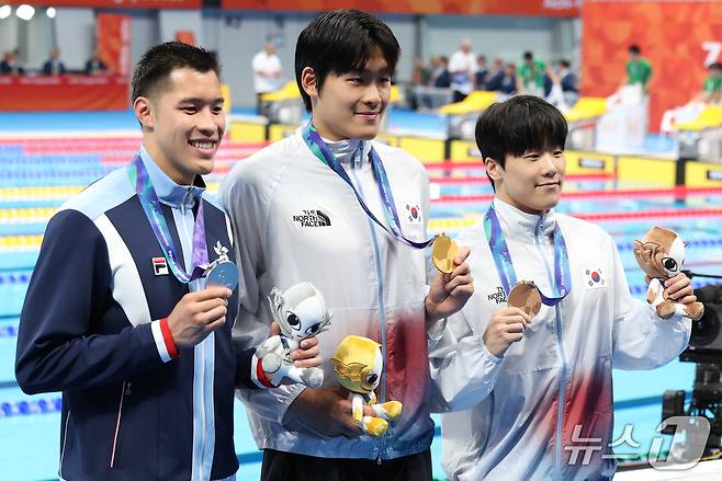 21일 도쿄 아쿠아틱스 센터에서 열린 2026 아이치·나고야 아시안게임 남자 50m 자유형 결승전에서 금메달을 획득한 김영범과 동메달을 획득한 지유찬이 메달을 들어 보이고 있다. 2026.9.21 ⓒ 뉴스1 김민지 기자