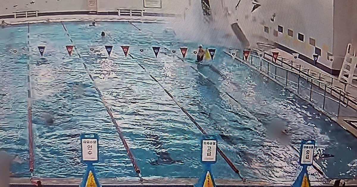 Car crashes into pool at sports center, swimmers rescue driver