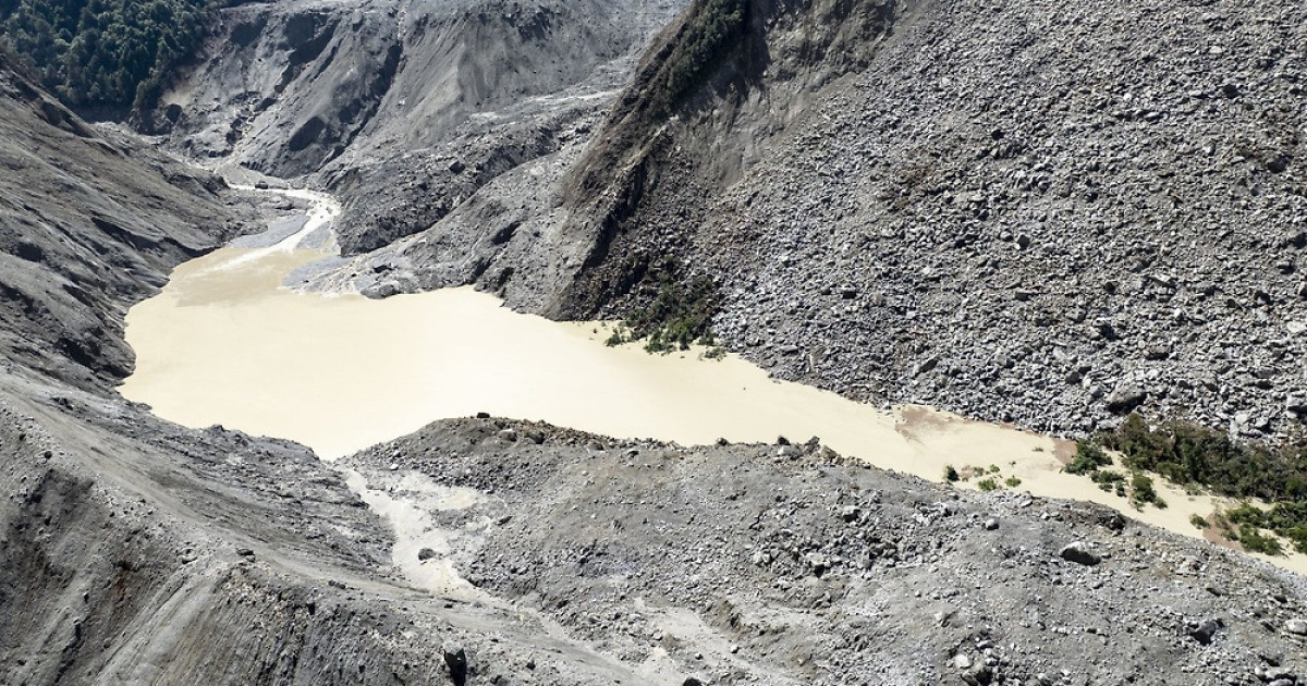 Newly formed natural dam overflowing in the Himalayas after Nepal flash flood