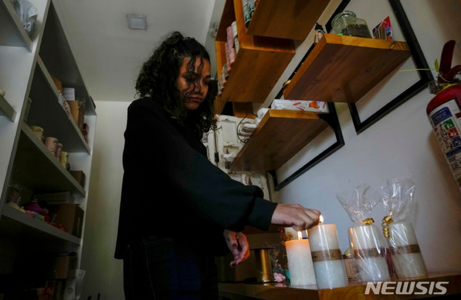 에콰도르 계획 정전으로 상점에 촛불 밝히는 점주