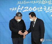 악수하는 박용만 회장과 김동명 위원장