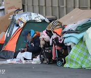 "Home Treatment" for the Homeless on the Street: No Treatment and No Travel Restrictions