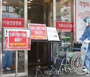 휠체어 옮기는 코로나19 거점전담병원 의료진