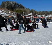 '눈썰매 타며 마이산 겨울동화축제 즐기는 가족들'