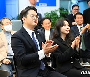 출구조사 결과 바라보며 박수치는 전용기 후보