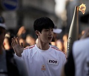 BTS's Jin carries Olympic torch in Paris — in pictures