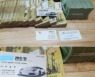 Picture of a Stack of Money Linking Lee Jae-myung to Organized Crime, Is It Fake? Democratic Party Claims It Found the Same Picture